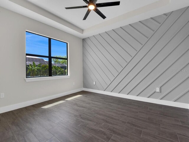 9257 King Hill St, Port Charlotte, FL 33981 - empty room with a ceiling fan and dark wood-style floors