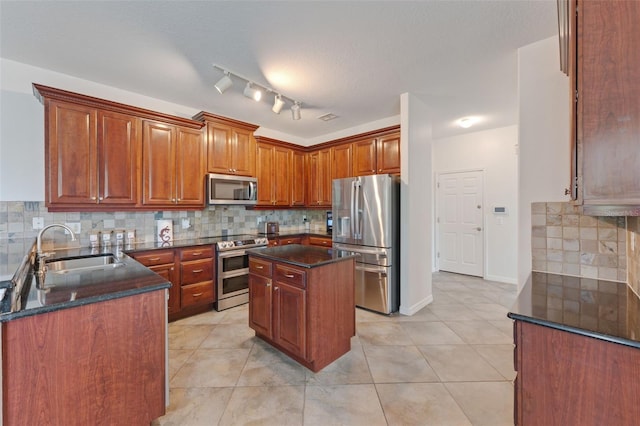 2681 Cabernet Cir, Ocoee, FL 34761 - kitchen featuring appliances with stainless steel finishes, a sink, tasteful backsplash, light tile patterned floors, and a kitchen island