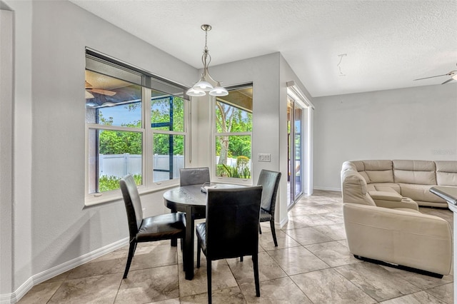 2681 Cabernet Cir, Ocoee, FL 34761 - tiled dining space featuring a textured ceiling, baseboards, and a ceiling fan