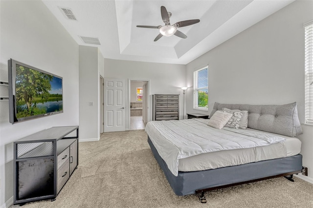 2681 Cabernet Cir, Ocoee, FL 34761 - bedroom featuring light colored carpet, a raised ceiling, baseboards, and connected bathroom