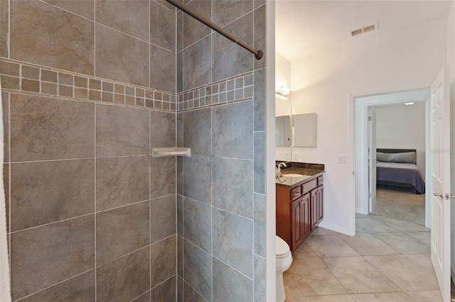 2681 Cabernet Cir, Ocoee, FL 34761 - ensuite bathroom featuring vanity, tile patterned flooring, a tile shower, toilet, and baseboards