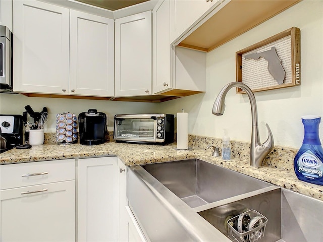 135 Florida Blvd, Crystal Beach, FL 34681 - kitchen featuring a sink, white cabinets, and stainless steel microwave