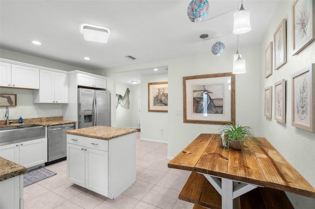 135 Florida Blvd, Crystal Beach, FL 34681 - kitchen featuring stainless steel appliances, white cabinetry, pendant lighting, light stone countertops, and recessed lighting