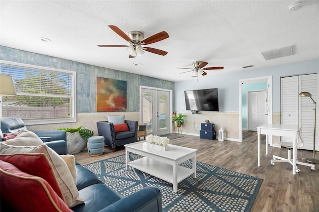 135 Florida Blvd, Crystal Beach, FL 34681 - living room featuring plenty of natural light, wood finished floors, a textured ceiling, a ceiling fan, and baseboards