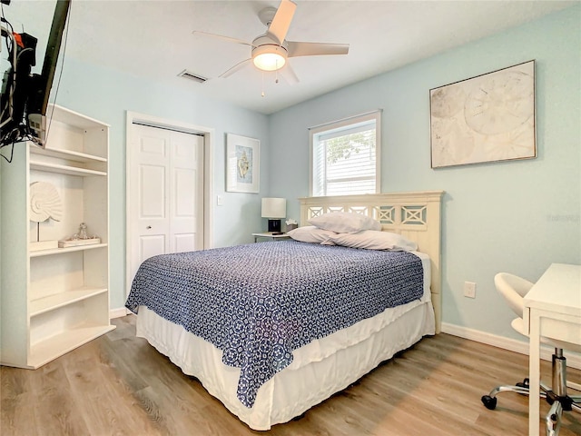 135 Florida Blvd, Crystal Beach, FL 34681 - bedroom with a closet, wood finished floors, baseboards, and ceiling fan