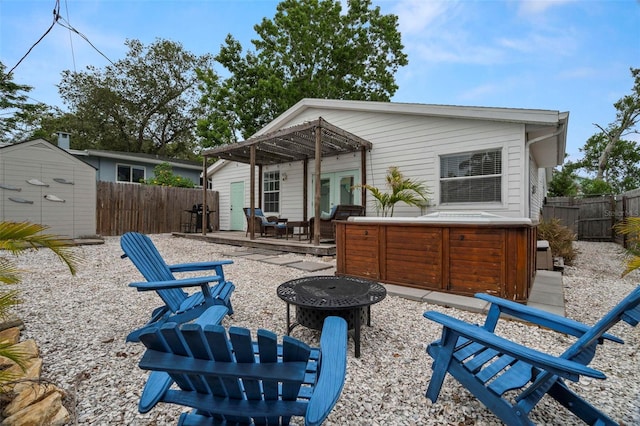 135 Florida Blvd, Crystal Beach, FL 34681 - back of property featuring a hot tub, a fire pit, french doors, a fenced backyard, and a patio area