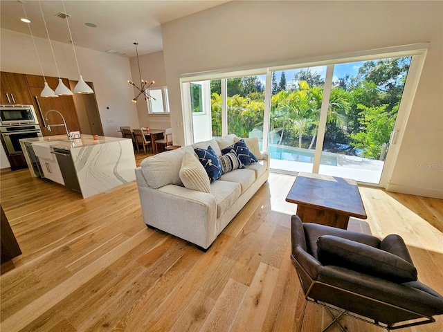 2408 Nassau St, Sarasota, FL 34231 - living area with a chandelier and light wood-style floors