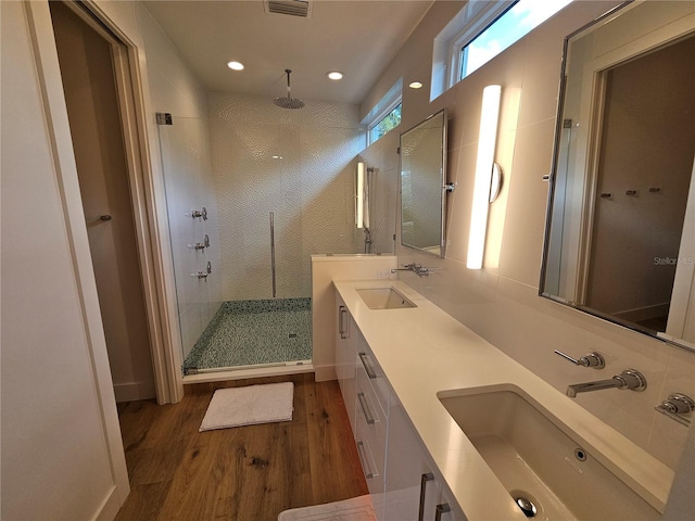 2408 Nassau St, Sarasota, FL 34231 - bathroom with wood finished floors, a tile shower, double vanity, and recessed lighting