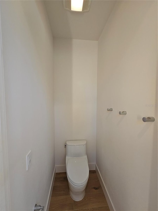 2408 Nassau St, Sarasota, FL 34231 - bathroom featuring wood finished floors, toilet, and baseboards