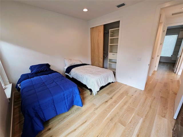 2408 Nassau St, Sarasota, FL 34231 - bedroom with light wood-style flooring, a closet, recessed lighting, and baseboards