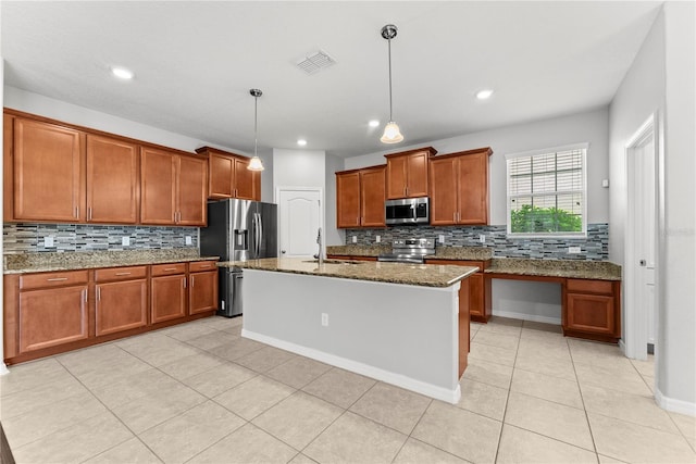 3426 Schoolhouse Rd, Harmony, FL 34773 - kitchen featuring appliances with stainless steel finishes, brown cabinetry, tasteful backsplash, dark stone countertops, and light tile patterned floors