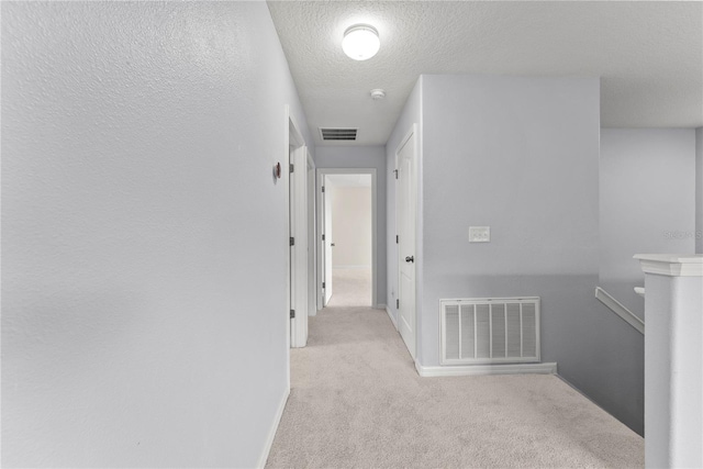 3426 Schoolhouse Rd, Harmony, FL 34773 - hall featuring carpet and a textured ceiling