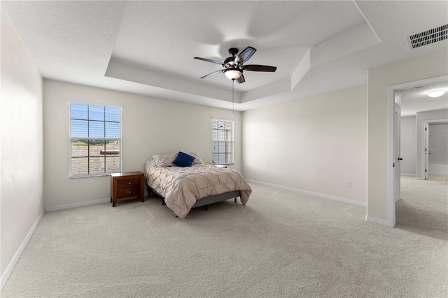3426 Schoolhouse Rd, Harmony, FL 34773 - bedroom with a raised ceiling, light carpet, multiple windows, and a ceiling fan