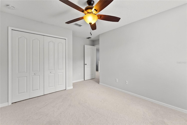 3426 Schoolhouse Rd, Harmony, FL 34773 - unfurnished bedroom with carpet, a closet, and a ceiling fan