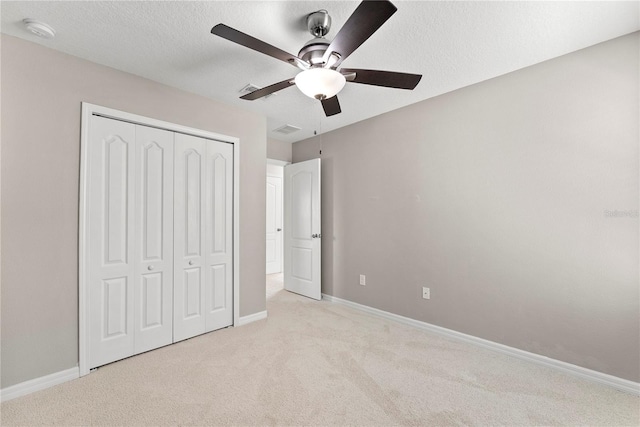 3426 Schoolhouse Rd, Harmony, FL 34773 - unfurnished bedroom featuring carpet, a closet, ceiling fan, and a textured ceiling