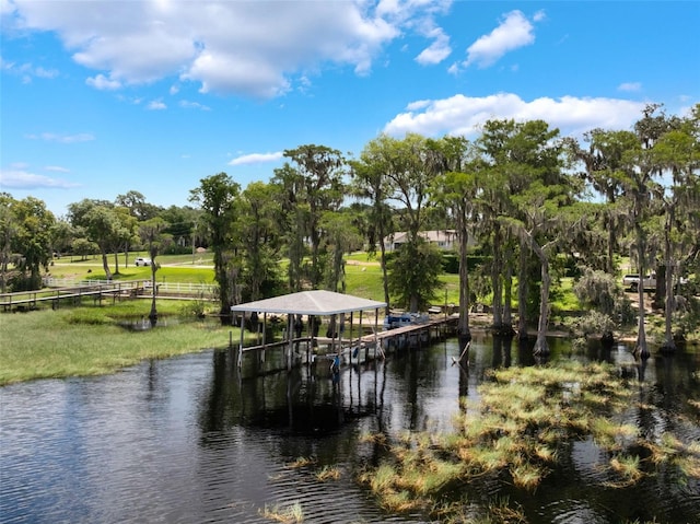 12130 Lakeshore Dr, Clermont, FL 34711 - dock featuring view of wooded area, a water view, and boat lift