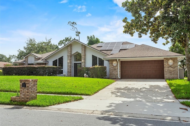 9774 Bohart Ct, Orlando, FL 32836 - mid-century inspired home with a front yard, roof mounted solar panels, an attached garage, and concrete driveway