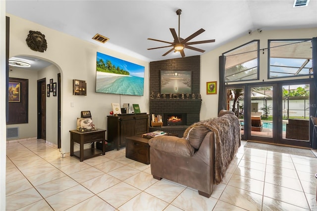 9774 Bohart Ct, Orlando, FL 32836 - living room featuring arched walkways, ceiling fan, light tile patterned flooring, vaulted ceiling, and a fireplace