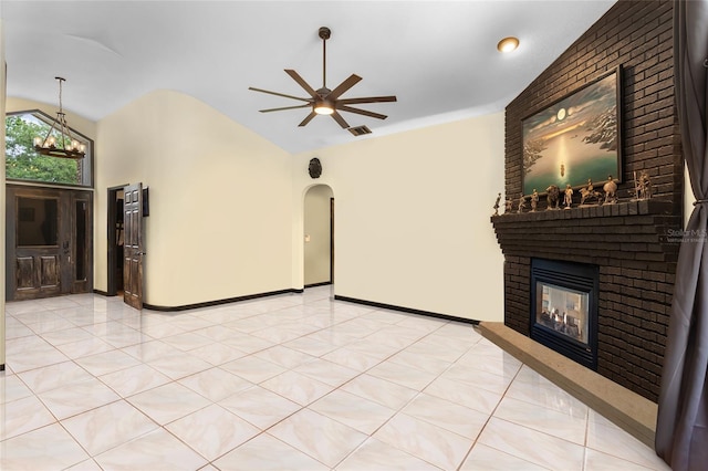 9774 Bohart Ct, Orlando, FL 32836 - unfurnished living room with a fireplace, a ceiling fan, arched walkways, lofted ceiling, and a chandelier