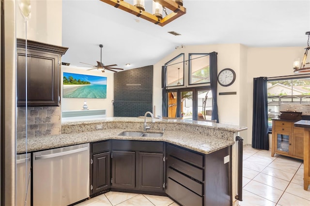 9774 Bohart Ct, Orlando, FL 32836 - kitchen featuring stainless steel dishwasher, lofted ceiling, a peninsula, a ceiling fan, and light tile patterned floors