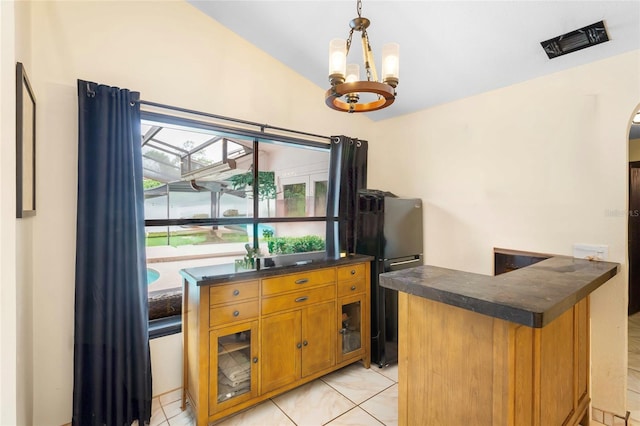 9774 Bohart Ct, Orlando, FL 32836 - bar featuring freestanding refrigerator, a chandelier, lofted ceiling, hanging light fixtures, and light tile patterned floors