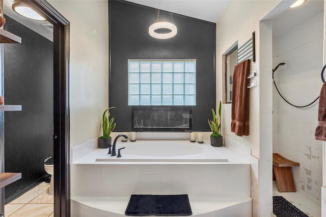 9774 Bohart Ct, Orlando, FL 32836 - bathroom featuring a garden tub, a tile shower, and tile patterned flooring