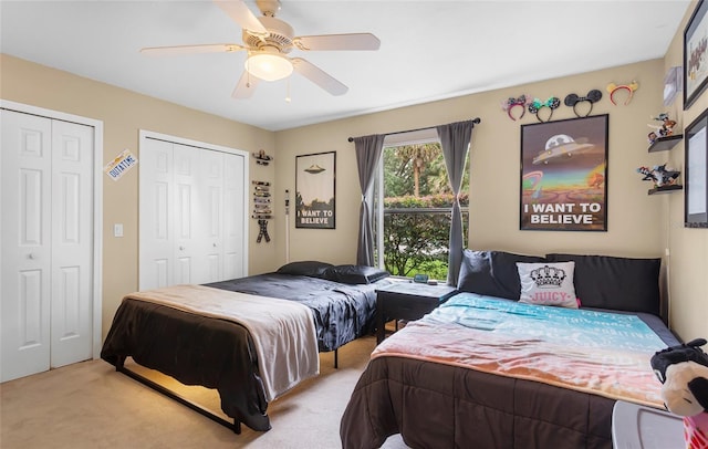 9774 Bohart Ct, Orlando, FL 32836 - bedroom with two closets, light colored carpet, and a ceiling fan
