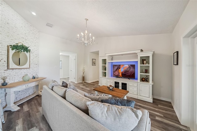 8473 Granada Blvd, Orlando, FL 32836 - living area featuring vaulted ceiling, dark wood finished floors, arched walkways, a chandelier, and a textured ceiling