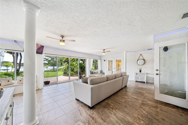 8473 Granada Blvd, Orlando, FL 32836 - living room featuring ornate columns, ceiling fan, a textured ceiling, and a water view