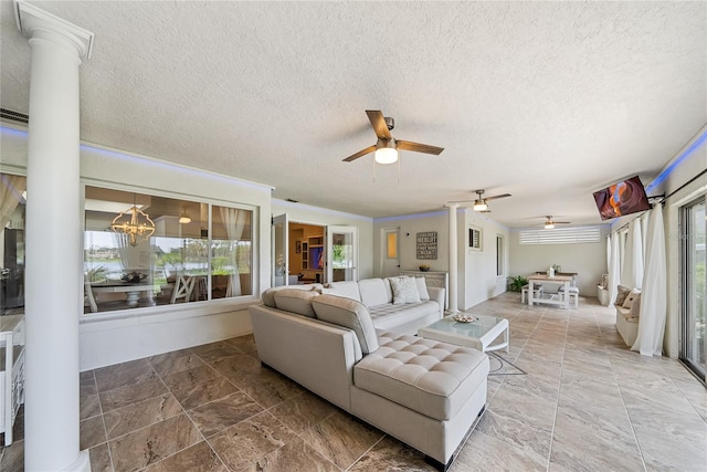 8473 Granada Blvd, Orlando, FL 32836 - living room with ceiling fan, ornate columns, a textured ceiling, stone finish flooring, and a chandelier