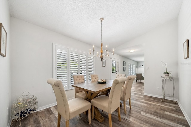 8473 Granada Blvd, Orlando, FL 32836 - dining area with a chandelier, wood finished floors, lofted ceiling, a textured ceiling, and baseboards