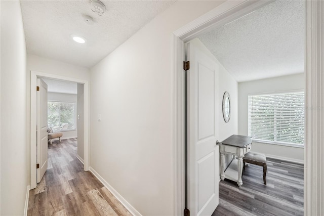 8473 Granada Blvd, Orlando, FL 32836 - hallway featuring a textured ceiling, wood finished floors, and baseboards