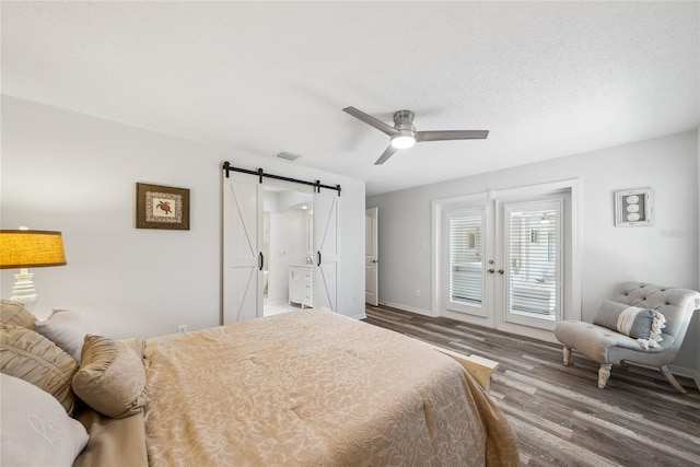 8473 Granada Blvd, Orlando, FL 32836 - bedroom with a barn door, access to outside, wood finished floors, french doors, and a ceiling fan