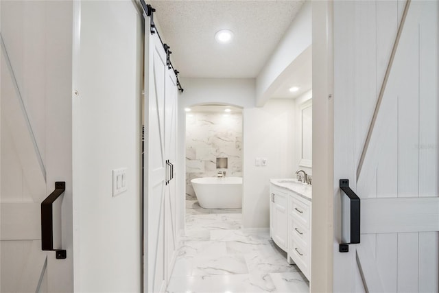 8473 Granada Blvd, Orlando, FL 32836 - full bath featuring vanity, recessed lighting, marble finish flooring, a freestanding bath, and a textured ceiling