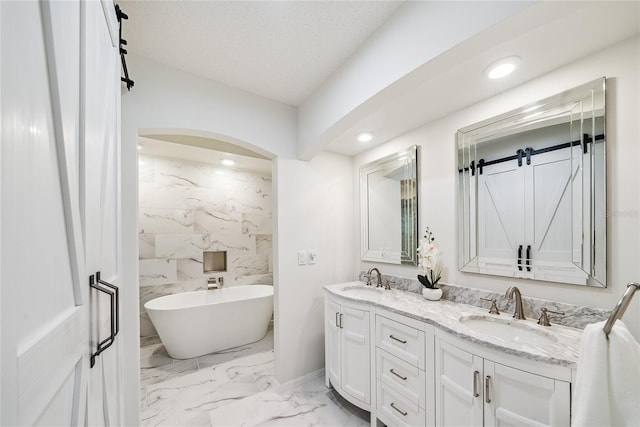 8473 Granada Blvd, Orlando, FL 32836 - bathroom with double vanity, a soaking tub, marble finish floors, recessed lighting, and baseboards