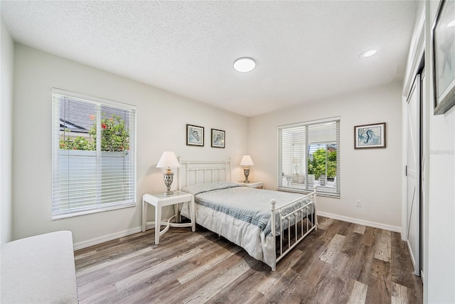8473 Granada Blvd, Orlando, FL 32836 - bedroom with wood finished floors, baseboards, recessed lighting, a textured ceiling, and a closet