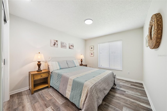 8473 Granada Blvd, Orlando, FL 32836 - bedroom with a textured ceiling, wood finished floors, and baseboards