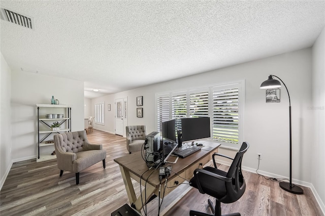 8473 Granada Blvd, Orlando, FL 32836 - home office featuring wood finished floors, a textured ceiling, and baseboards