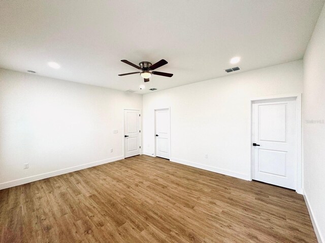 319 Anchovie Ct, Poinciana, FL 34759 - unfurnished room featuring wood finished floors, baseboards, ceiling fan, and recessed lighting