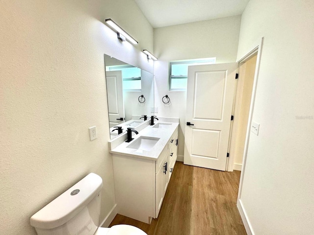 319 Anchovie Ct, Poinciana, FL 34759 - bathroom featuring toilet, wood finished floors, and double vanity