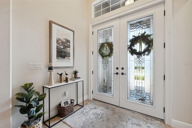 9426 Burnam Dr, Weeki Wachee, FL 34613 - foyer with plenty of natural light, baseboards, and french doors