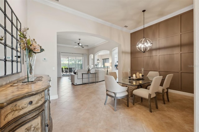 9426 Burnam Dr, Weeki Wachee, FL 34613 - dining room featuring arched walkways, crown molding, a chandelier, light tile patterned floors, and a ceiling fan