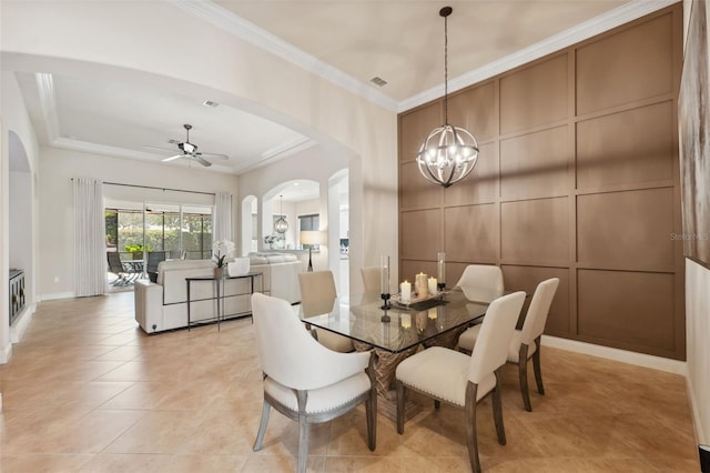 9426 Burnam Dr, Weeki Wachee, FL 34613 - dining area with arched walkways, a chandelier, ornamental molding, a ceiling fan, and light tile patterned floors