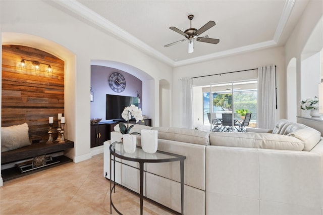 9426 Burnam Dr, Weeki Wachee, FL 34613 - living area featuring ceiling fan, arched walkways, light tile patterned floors, and crown molding