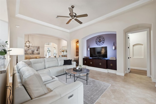 9426 Burnam Dr, Weeki Wachee, FL 34613 - living room with arched walkways, ceiling fan, crown molding, light tile patterned floors, and baseboards