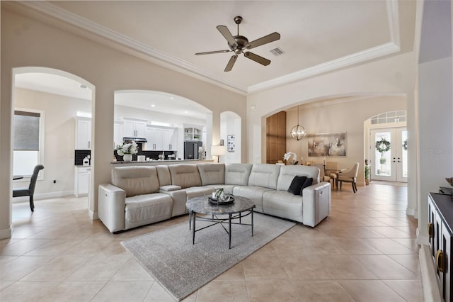 9426 Burnam Dr, Weeki Wachee, FL 34613 - living room featuring arched walkways, a ceiling fan, light tile patterned floors, ornamental molding, and french doors