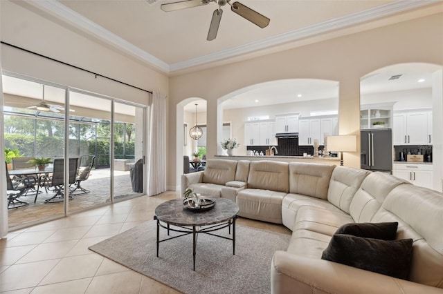 9426 Burnam Dr, Weeki Wachee, FL 34613 - living room featuring ceiling fan, arched walkways, crown molding, light tile patterned floors, and recessed lighting