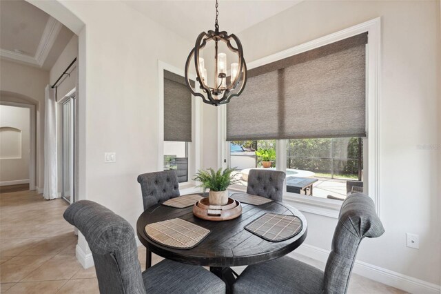 9426 Burnam Dr, Weeki Wachee, FL 34613 - dining space featuring arched walkways, a chandelier, light tile patterned floors, and baseboards