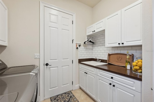 9426 Burnam Dr, Weeki Wachee, FL 34613 - laundry area featuring cabinet space, independent washer and dryer, and light tile patterned floors