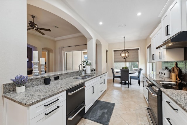 9426 Burnam Dr, Weeki Wachee, FL 34613 - kitchen with electric stove, a sink, dishwasher, under cabinet range hood, and ceiling fan